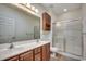 Inviting bathroom featuring double sink vanity, glass shower door, and a cabinet at 204 Rose Water Loop # 204, Myrtle Beach, SC 29588