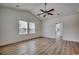Spacious bedroom featuring vaulted ceilings, ample natural light, and stylish laminate flooring at 204 Rose Water Loop # 204, Myrtle Beach, SC 29588