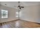 A bright bedroom features hardwood flooring, natural lighting and a modern ceiling fan at 204 Rose Water Loop # 204, Myrtle Beach, SC 29588