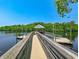 View of the boardwalk leading to a covered pier on the river, providing access for boats and fishing at 204 Rose Water Loop # 204, Myrtle Beach, SC 29588