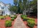 Landscaped community grounds feature a brick pathway leading to charming benches and lush greenery, perfect for relaxation at 204 Rose Water Loop # 204, Myrtle Beach, SC 29588