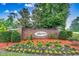Welcoming entrance to Riverbend, beautifully landscaped with vibrant plants and brick signage, creating a warm first impression at 204 Rose Water Loop # 204, Myrtle Beach, SC 29588
