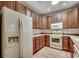 Functional kitchen featuring ample cabinet space, white appliances, and laminate flooring at 204 Rose Water Loop # 204, Myrtle Beach, SC 29588
