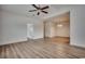 Open-concept living room with laminate flooring, ceiling fan, and access to other rooms at 204 Rose Water Loop # 204, Myrtle Beach, SC 29588