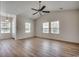 Well-lit living room featuring stylish laminate flooring, ceiling fan, and an open layout at 204 Rose Water Loop # 204, Myrtle Beach, SC 29588
