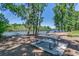 Lakeside picnic area with multiple tables and chairs, perfect for outdoor dining and enjoying nature's tranquility at 204 Rose Water Loop # 204, Myrtle Beach, SC 29588