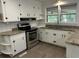 Functional kitchen featuring white cabinetry, modern stainless-steel appliances, and practical countertops at 205 S Oliver Blvd., Hemingway, SC 29554