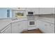 Bright kitchen featuring white appliances, including a microwave, oven, and corner sink at 2241 Waterview Dr. # 514, North Myrtle Beach, SC 29582