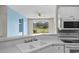 Bright kitchen features a double sink and a view of the landscaped lawn and golf course at 2241 Waterview Dr. # 514, North Myrtle Beach, SC 29582