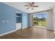 Sunny living room with built-in shelving, a fan, and glass doors opening to the outdoors at 2241 Waterview Dr. # 514, North Myrtle Beach, SC 29582