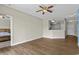 Spacious living room with wood floors adjacent to an open kitchen and a view into the main bedroom at 2241 Waterview Dr. # 514, North Myrtle Beach, SC 29582