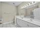 Bright main bathroom with double vanity, tiled floors, and a glass-doored shower/tub at 2241 Waterview Dr. # 514, North Myrtle Beach, SC 29582