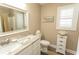 Neutral bathroom with marble countertops, framed mirror, and coastal decor at 2428 Little River Neck Rd. # 101, North Myrtle Beach, SC 29582