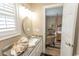 Bright bathroom with marble countertops, a decorative mirror, and a view to bedroom at 2428 Little River Neck Rd. # 101, North Myrtle Beach, SC 29582