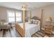 Bedroom features a stylish four-poster bed, wood floors, and a comfortable chair at 2428 Little River Neck Rd. # 101, North Myrtle Beach, SC 29582