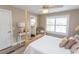Bedroom features a stylish four-poster bed, wood floors, and view into an en suite bathroom at 2428 Little River Neck Rd. # 101, North Myrtle Beach, SC 29582