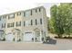 Exterior view of a townhome showcasing architectural details, including a garage and covered porch at 2428 Little River Neck Rd. # 101, North Myrtle Beach, SC 29582