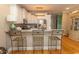 Open kitchen with bar-style seating, modern appliances, and hardwood floors, perfect for entertaining at 2428 Little River Neck Rd. # 101, North Myrtle Beach, SC 29582