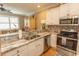 Bright kitchen featuring stainless steel appliances, granite counters, and custom cabinetry at 2428 Little River Neck Rd. # 101, North Myrtle Beach, SC 29582