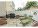 Cozy fenced-in patio with pavers, grill, lounge chairs, and seating area at 2428 Little River Neck Rd. # 101, North Myrtle Beach, SC 29582