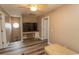 Comfortable sitting room features a TV, natural light, a ceiling fan, and a decorative stool at 2428 Little River Neck Rd. # 101, North Myrtle Beach, SC 29582