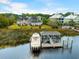 An aerial view of an estate home on the water with a boat and private dock at 2715 Ships Wheel Dr., North Myrtle Beach, SC 29582