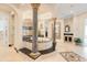 Elegant bathroom featuring a tiled tub, pillars, mosaic tilework, and a separate shower room at 2715 Ships Wheel Dr., North Myrtle Beach, SC 29582