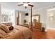 Well-lit bedroom with a four-poster bed, hardwood floors, and decorative furniture pieces at 2715 Ships Wheel Dr., North Myrtle Beach, SC 29582