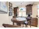Cozy dining area with dark wood cabinetry, granite countertop, and arched window offering ample natural light at 2715 Ships Wheel Dr., North Myrtle Beach, SC 29582