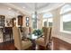 Elegant dining area featuring designer chandelier, large windows and wainscoting at 2715 Ships Wheel Dr., North Myrtle Beach, SC 29582