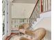 Elegant foyer featuring a staircase, decorative railing, and wicker seating area at 2715 Ships Wheel Dr., North Myrtle Beach, SC 29582