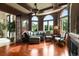 Comfortable living room with wood floors, a cozy fireplace, and views of the outdoors through arched windows at 2715 Ships Wheel Dr., North Myrtle Beach, SC 29582
