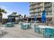 Outdoor deck features tables, chairs, umbrellas, and ocean views, with a building in the background at 2801 S Ocean Blvd. # 835, North Myrtle Beach, SC 29582