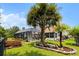 A beautifully landscaped backyard features a pool and mature palms at 29 Saltwind Loop, Murrells Inlet, SC 29576