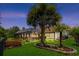 Backyard with tropical landscaping, water feature, and screened-in pool area at 29 Saltwind Loop, Murrells Inlet, SC 29576
