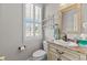 A half bathroom featuring a white vanity and shuttered windows at 29 Saltwind Loop, Murrells Inlet, SC 29576