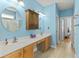 Bathroom featuring double sinks, wood cabinets, bright lighting, and modern fixtures at 29 Saltwind Loop, Murrells Inlet, SC 29576