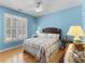 Comfortable bedroom with hardwood floors, plantation shutters, ceiling fan, and side tables at 29 Saltwind Loop, Murrells Inlet, SC 29576