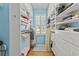 Spacious walk-in closet with custom shelving, cabinets, hardwood floors, and a window for natural light at 29 Saltwind Loop, Murrells Inlet, SC 29576