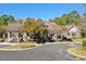 Community clubhouse featuring beautiful landscaping, paved driveway, and manicured lawn at 29 Saltwind Loop, Murrells Inlet, SC 29576