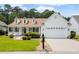 Charming home with manicured lawn, front porch with rocking chairs, and a two-car garage at 29 Saltwind Loop, Murrells Inlet, SC 29576