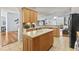 Modern kitchen with island, light wood cabinetry, and tile flooring at 29 Saltwind Loop, Murrells Inlet, SC 29576