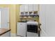 A laundry room features a washer and dryer and built-in shelving at 29 Saltwind Loop, Murrells Inlet, SC 29576