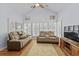 Bright living room with high ceilings, hardwood floors, large windows with shutters, and dual reclining sofas at 29 Saltwind Loop, Murrells Inlet, SC 29576