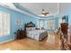 Spacious main bedroom featuring a tray ceiling, hardwood floors, and plantation shutters for ample sunlight at 29 Saltwind Loop, Murrells Inlet, SC 29576
