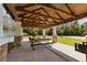 Outdoor pavilion with stone pillars, picnic tables, a grill, and a ceiling fan at 29 Saltwind Loop, Murrells Inlet, SC 29576