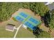 Aerial view of community pickleball courts with blue and green surface surrounded by trees and greenspace at 29 Saltwind Loop, Murrells Inlet, SC 29576
