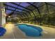 Screened-in pool area at dusk with an umbrella, outdoor furniture, and overhead lighting at 29 Saltwind Loop, Murrells Inlet, SC 29576