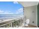 Relaxing balcony overlooking a sandy beach with chairs for a peaceful view at 300 N Ocean Blvd. # 723, North Myrtle Beach, SC 29582