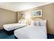 Comfortable bedroom with two beds, beach-themed artwork and coordinated decor at 300 N Ocean Blvd. # 723, North Myrtle Beach, SC 29582